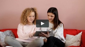 Women Sitting on a Couch - Using a Tablet Computer